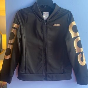 A jacket size 10/12 brand adidas it’s black with gold lettering on the sleeves